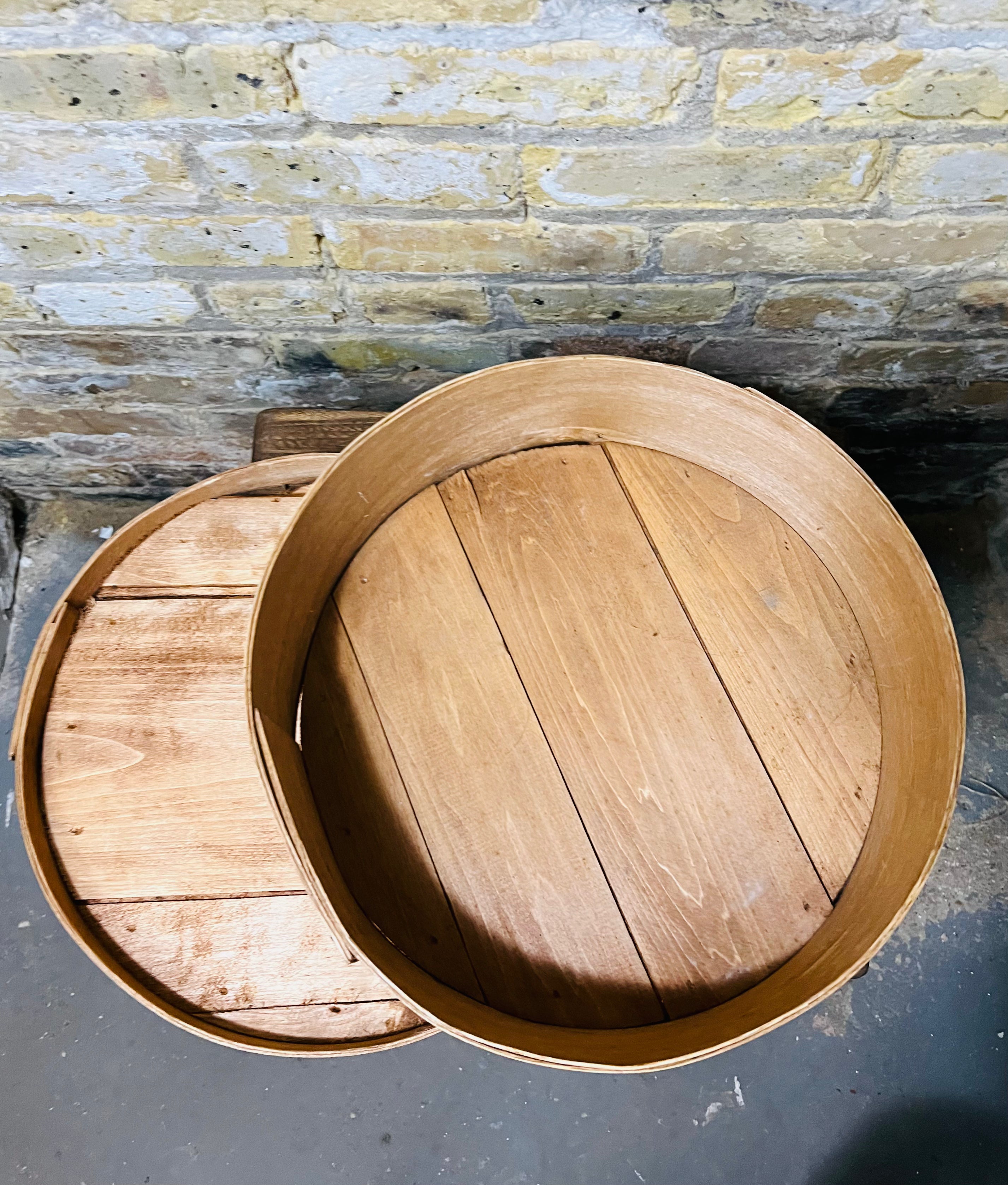 Vintage wooden cheese wheel storage box.