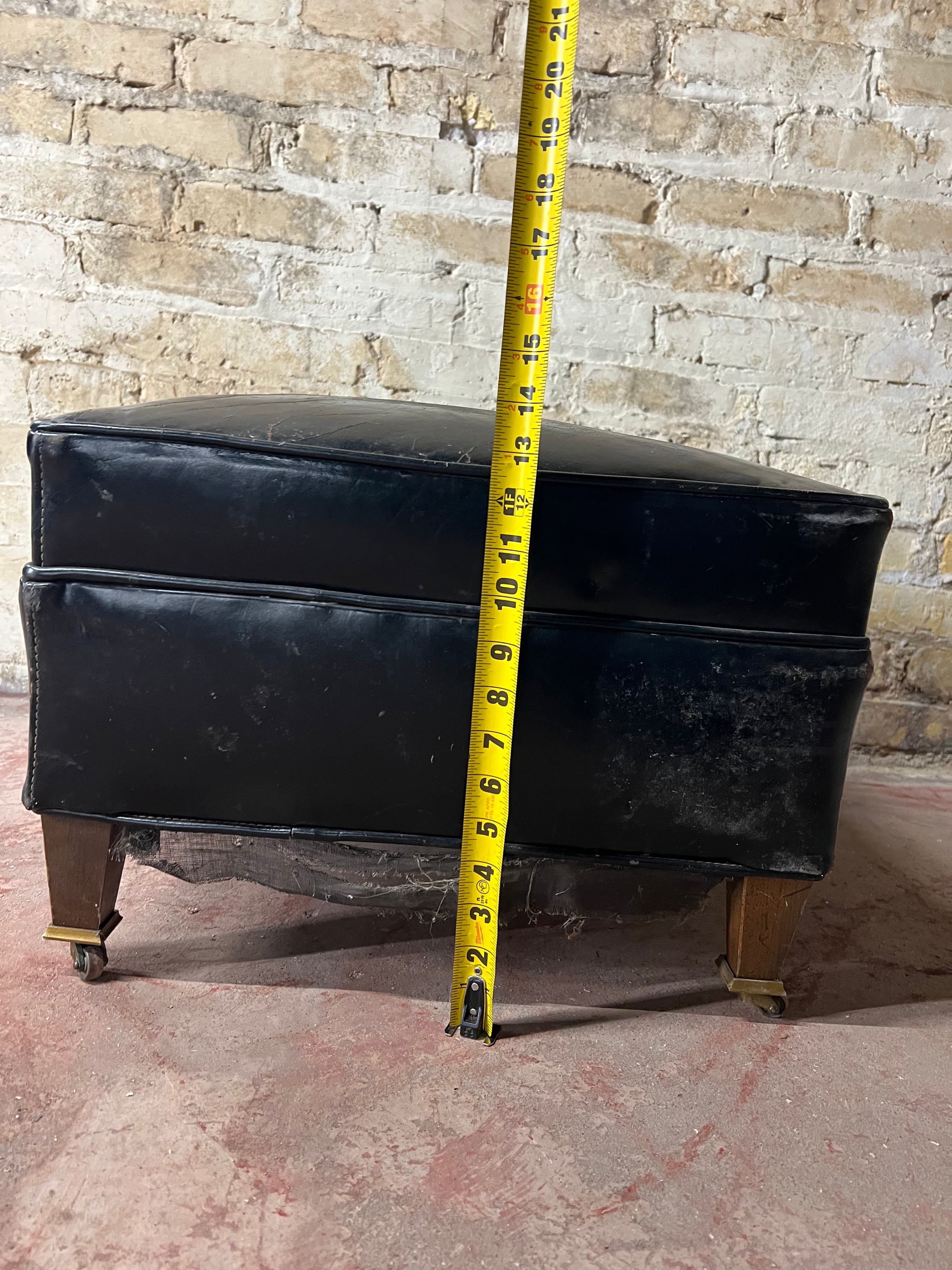 Vintage leather ottoman on wheels.
