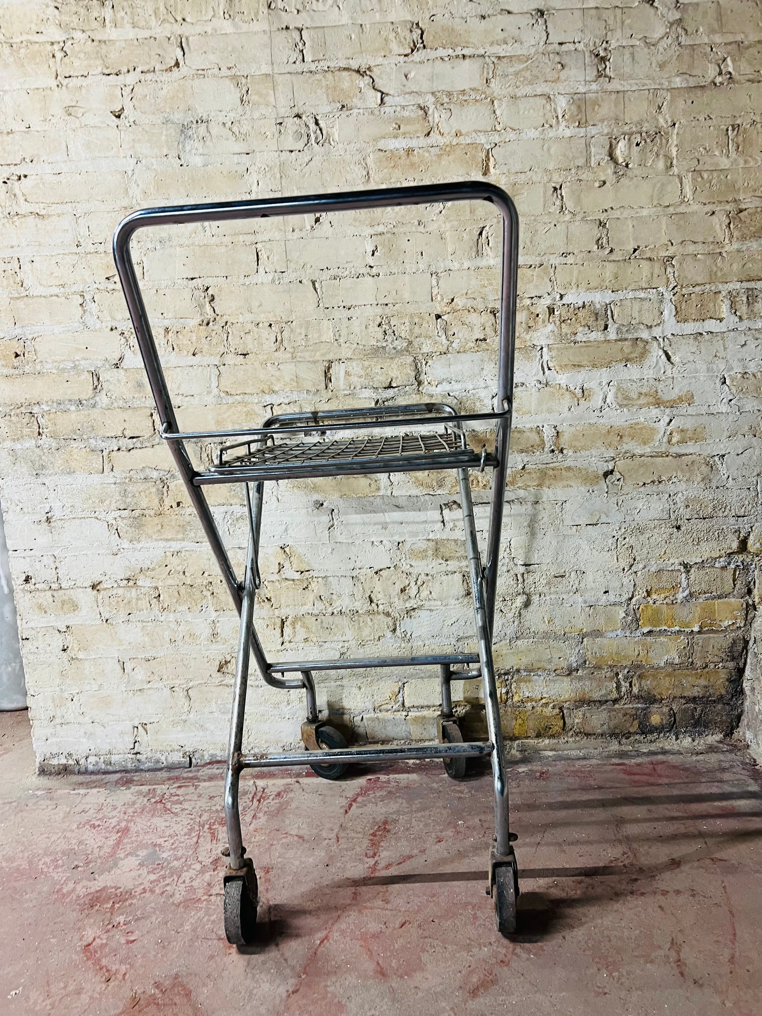 Vintage metal folding cart with wheels.