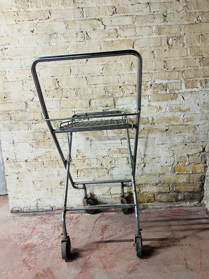 Vintage metal folding cart with wheels.