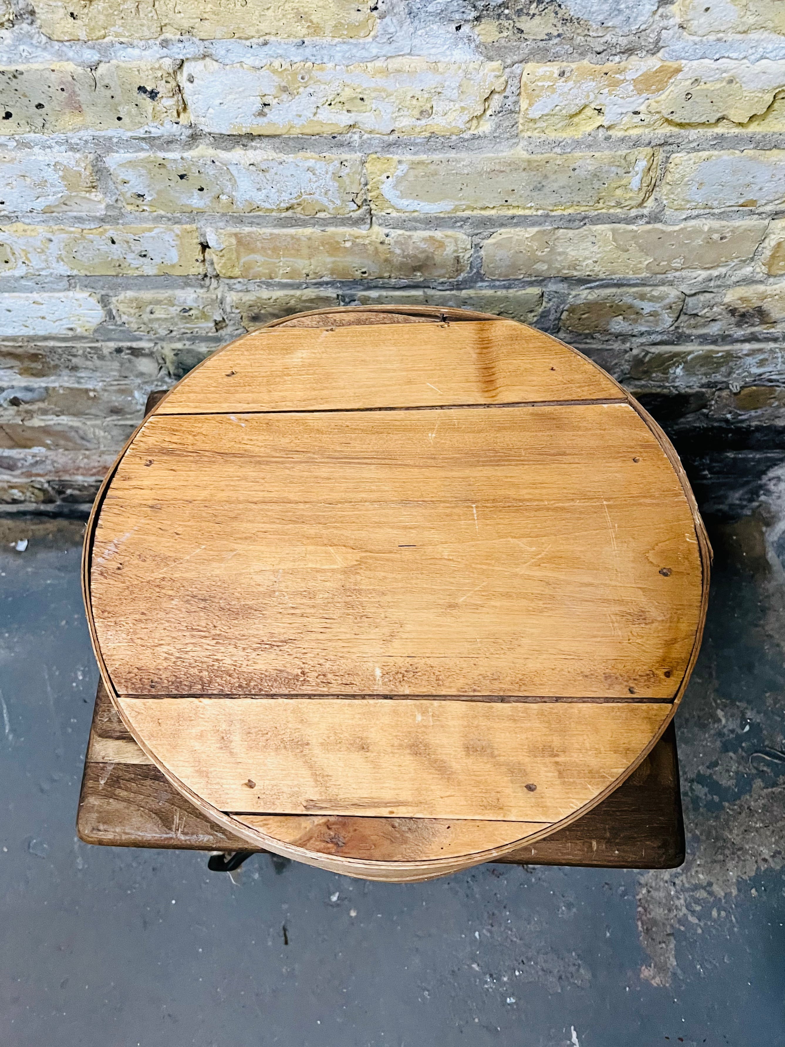 Vintage wooden cheese wheel storage box.