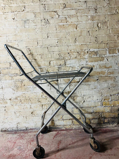 Vintage metal folding cart with wheels.
