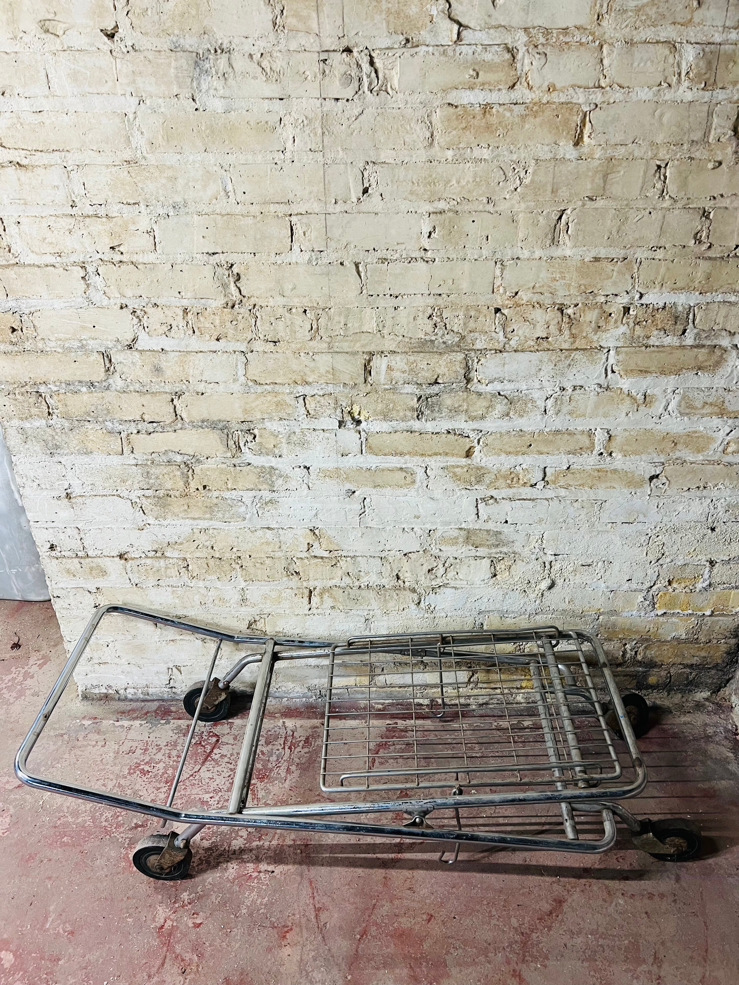 Vintage metal folding cart with wheels.