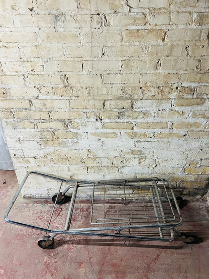 Vintage metal folding cart with wheels.