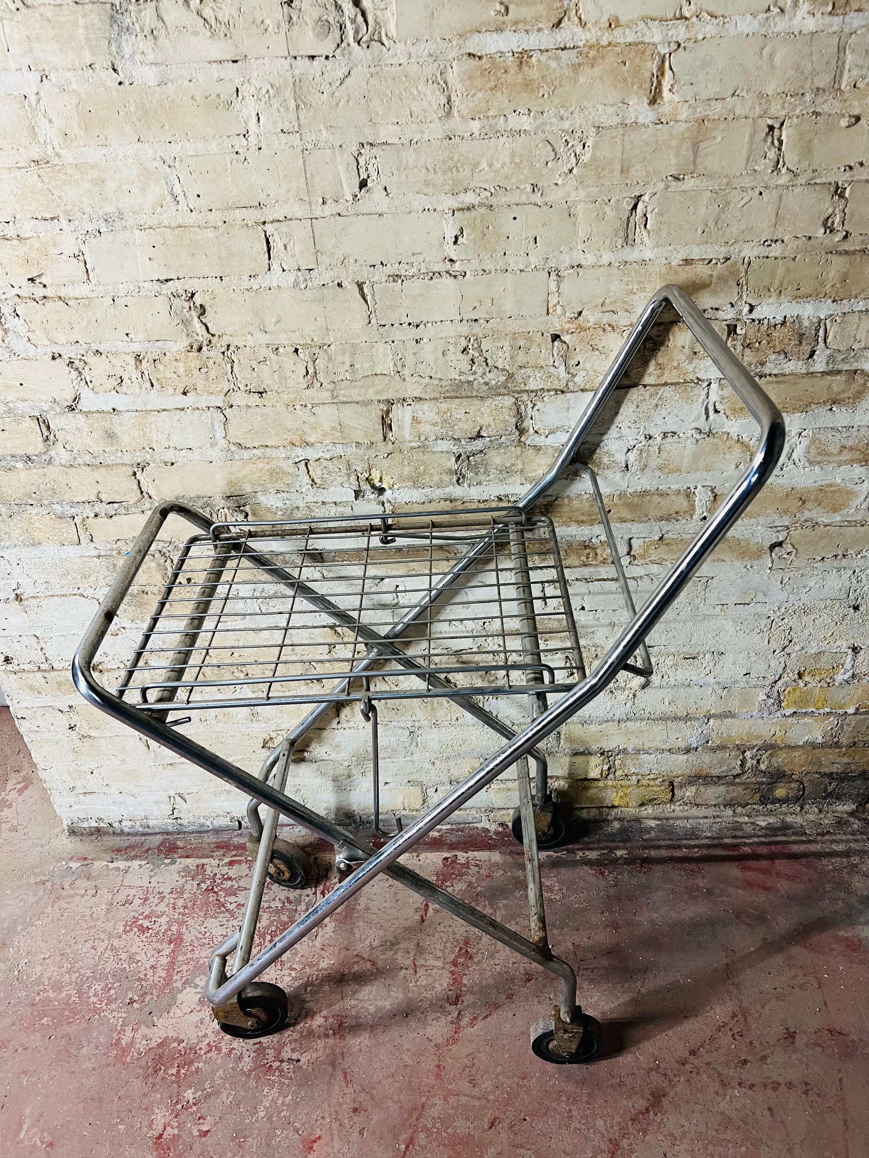 Vintage metal folding cart with wheels.