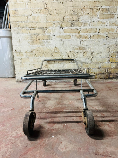 Vintage metal folding cart with wheels.