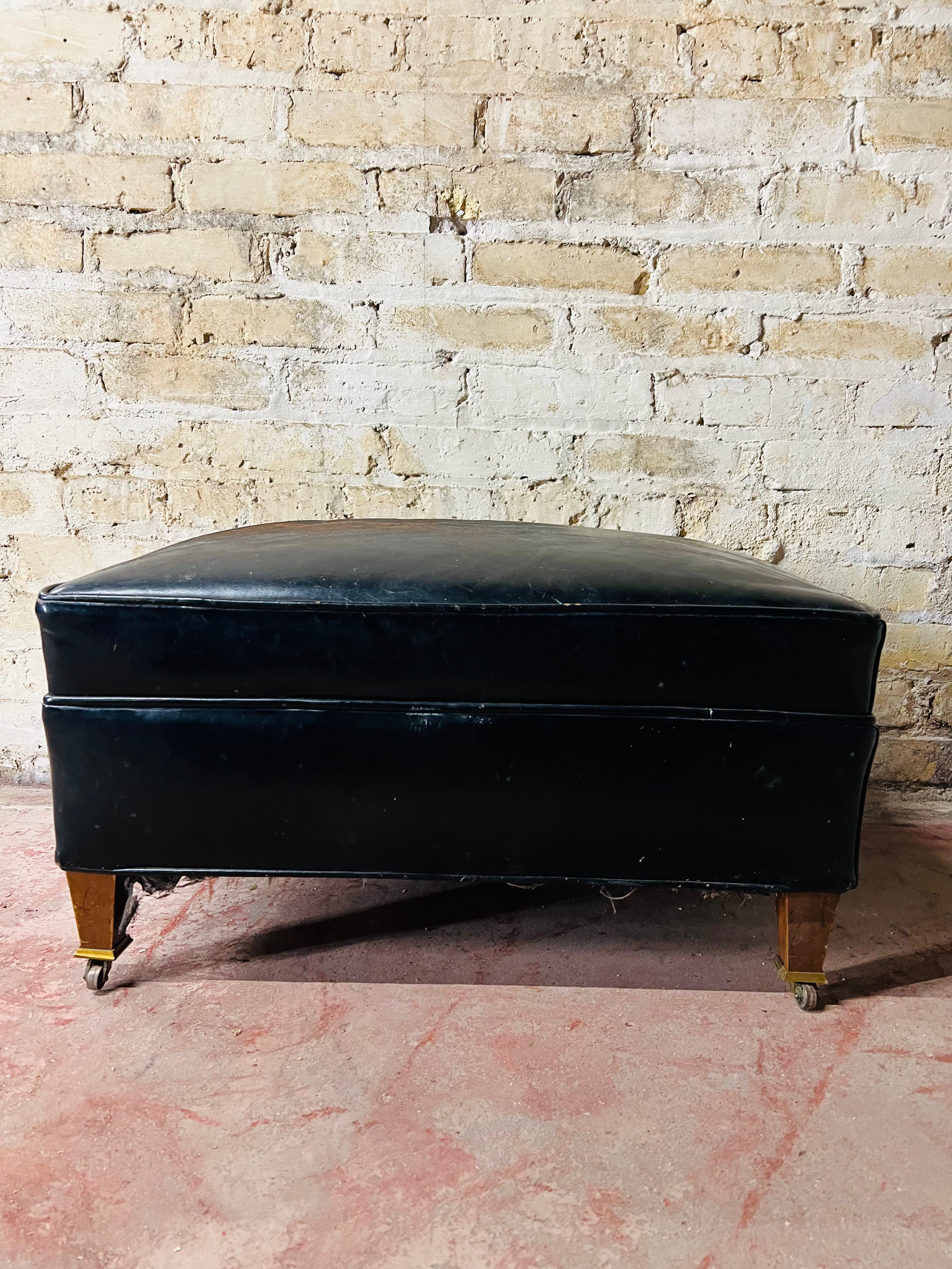 Vintage leather ottoman on wheels.
