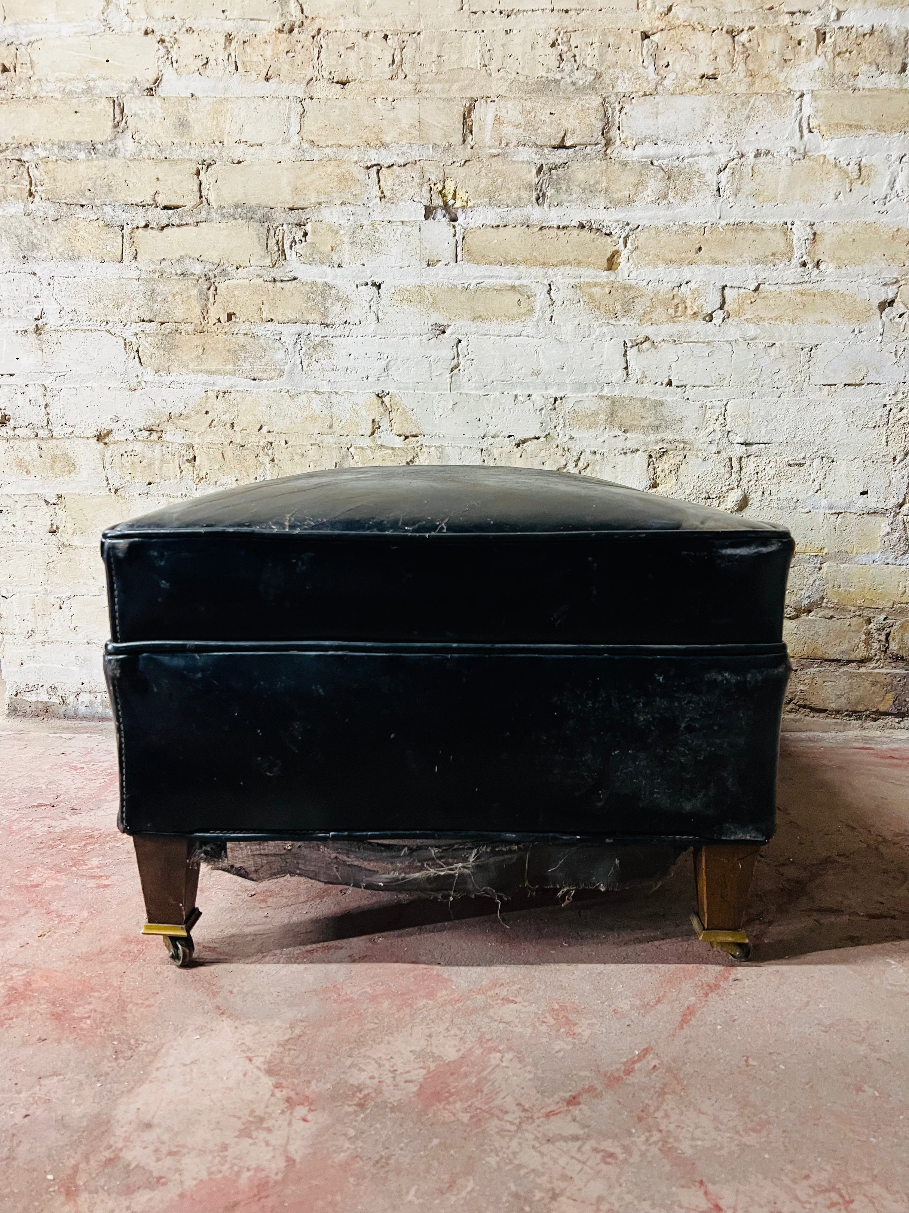 Vintage leather ottoman on wheels.