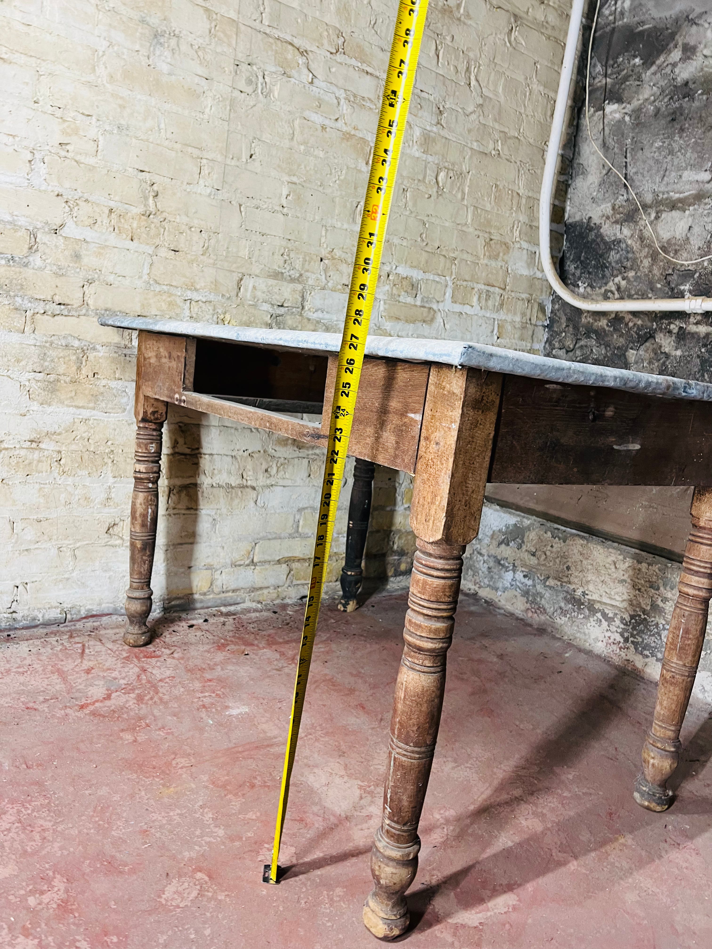 Vintage farm table with zinc top missing drawer.