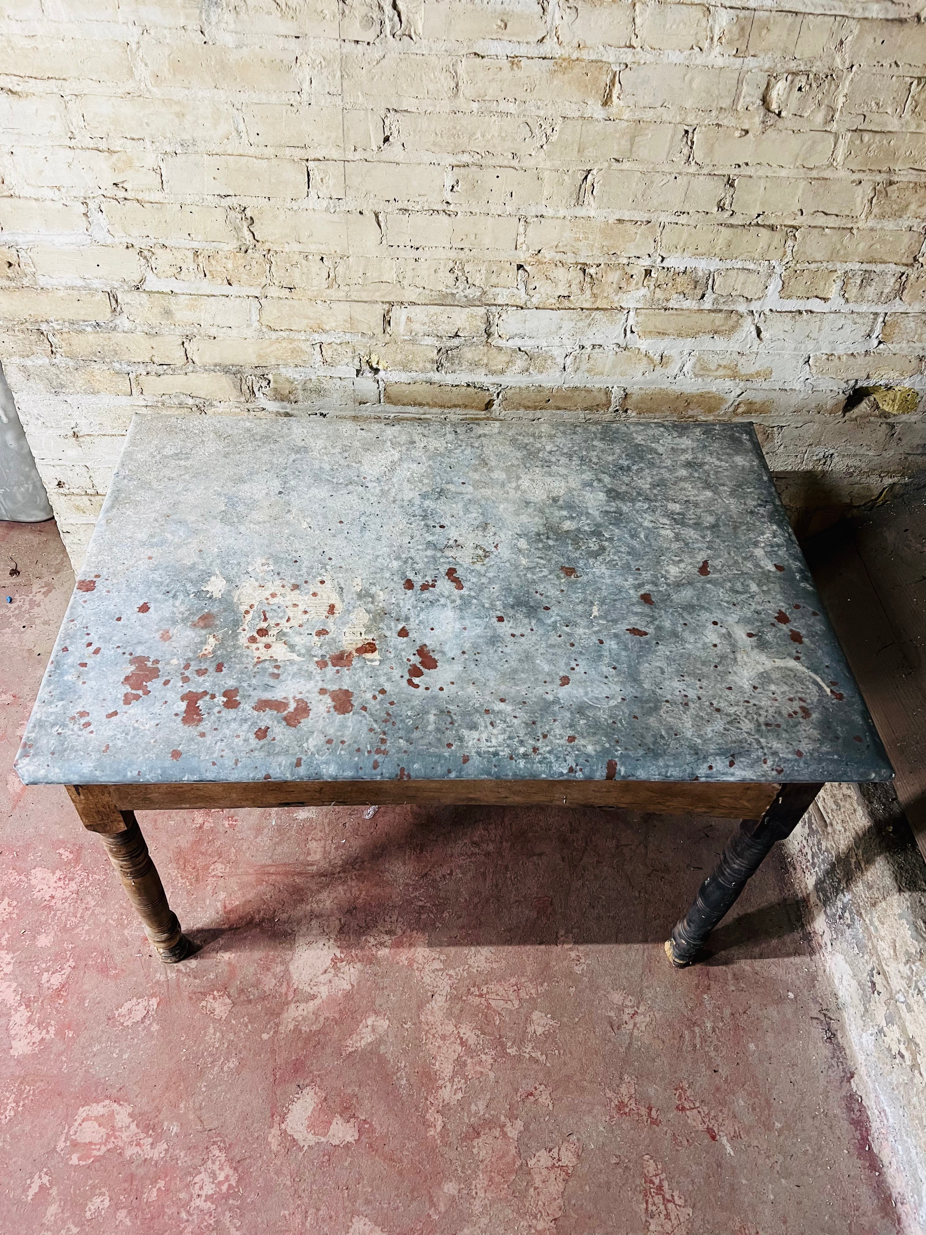 Vintage farm table with zinc top missing drawer.