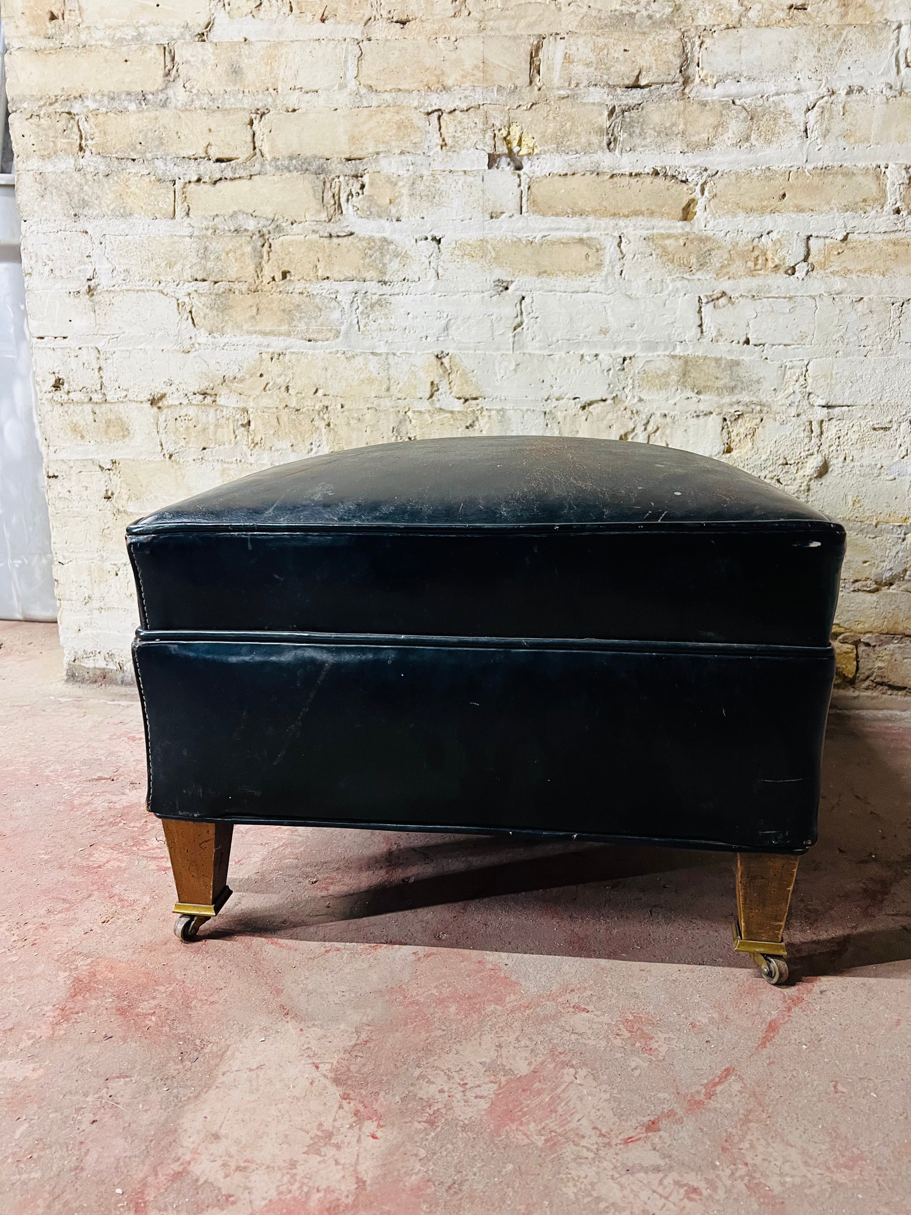 Vintage leather ottoman on wheels.