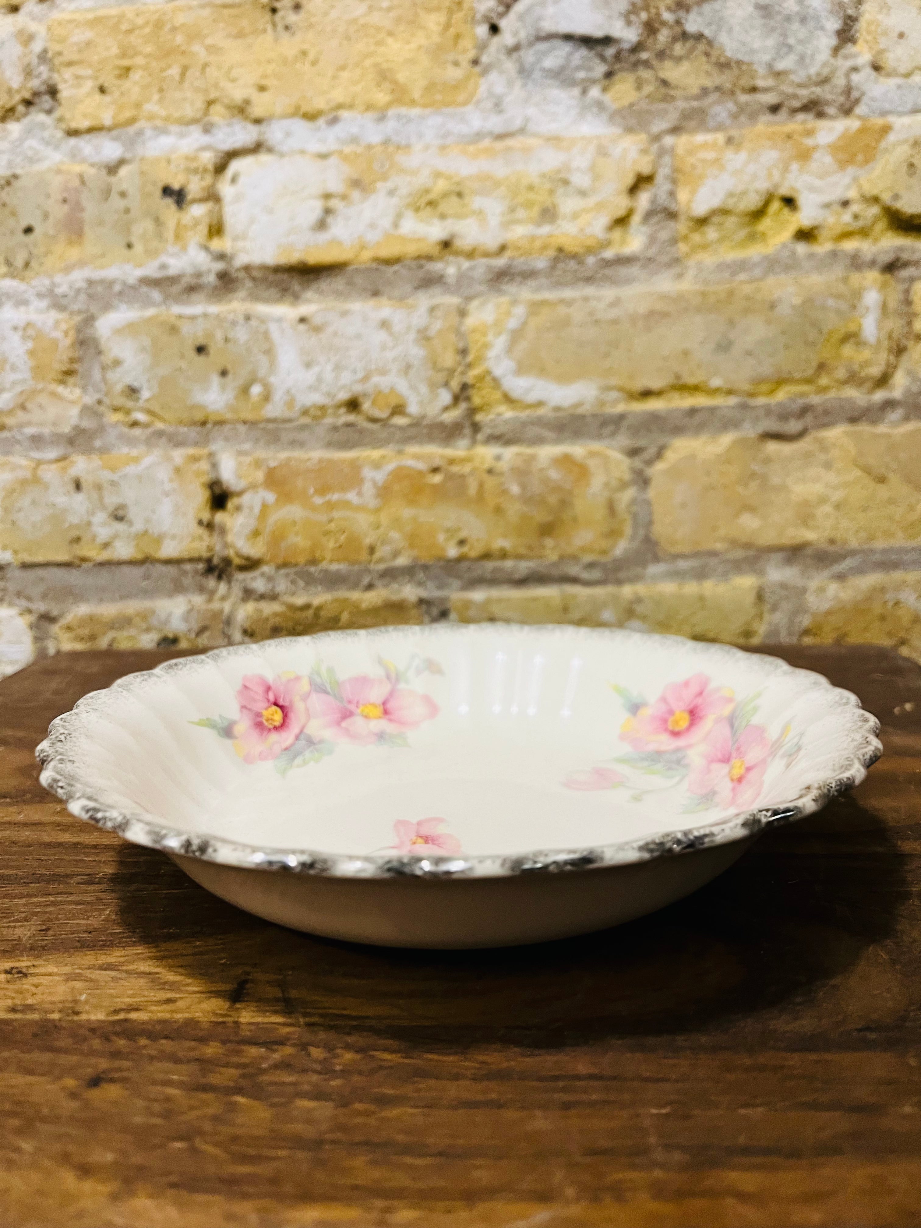 Vintage Sebring ivory porcelain bowl colored flower design.