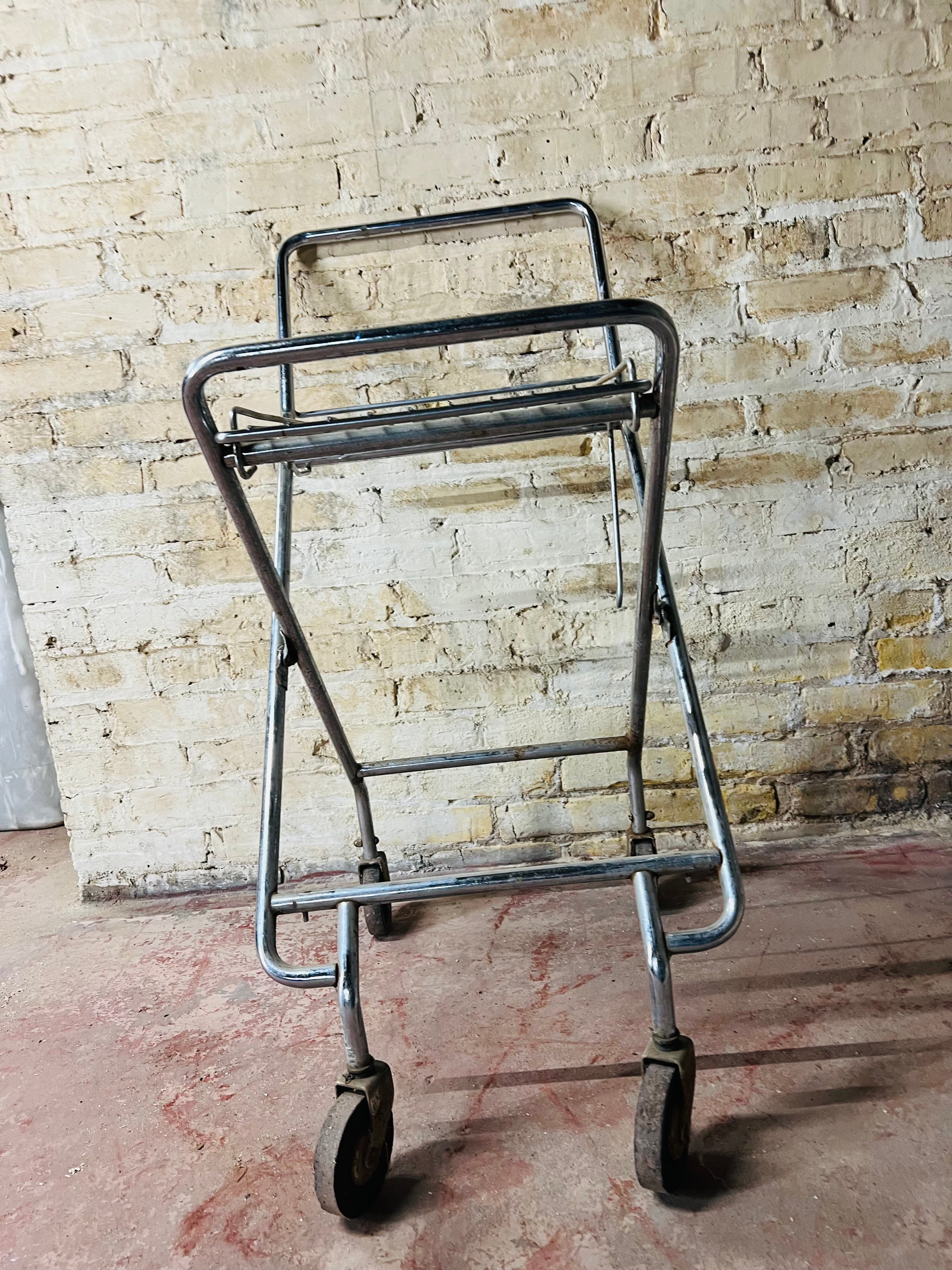 Vintage metal folding cart with wheels.