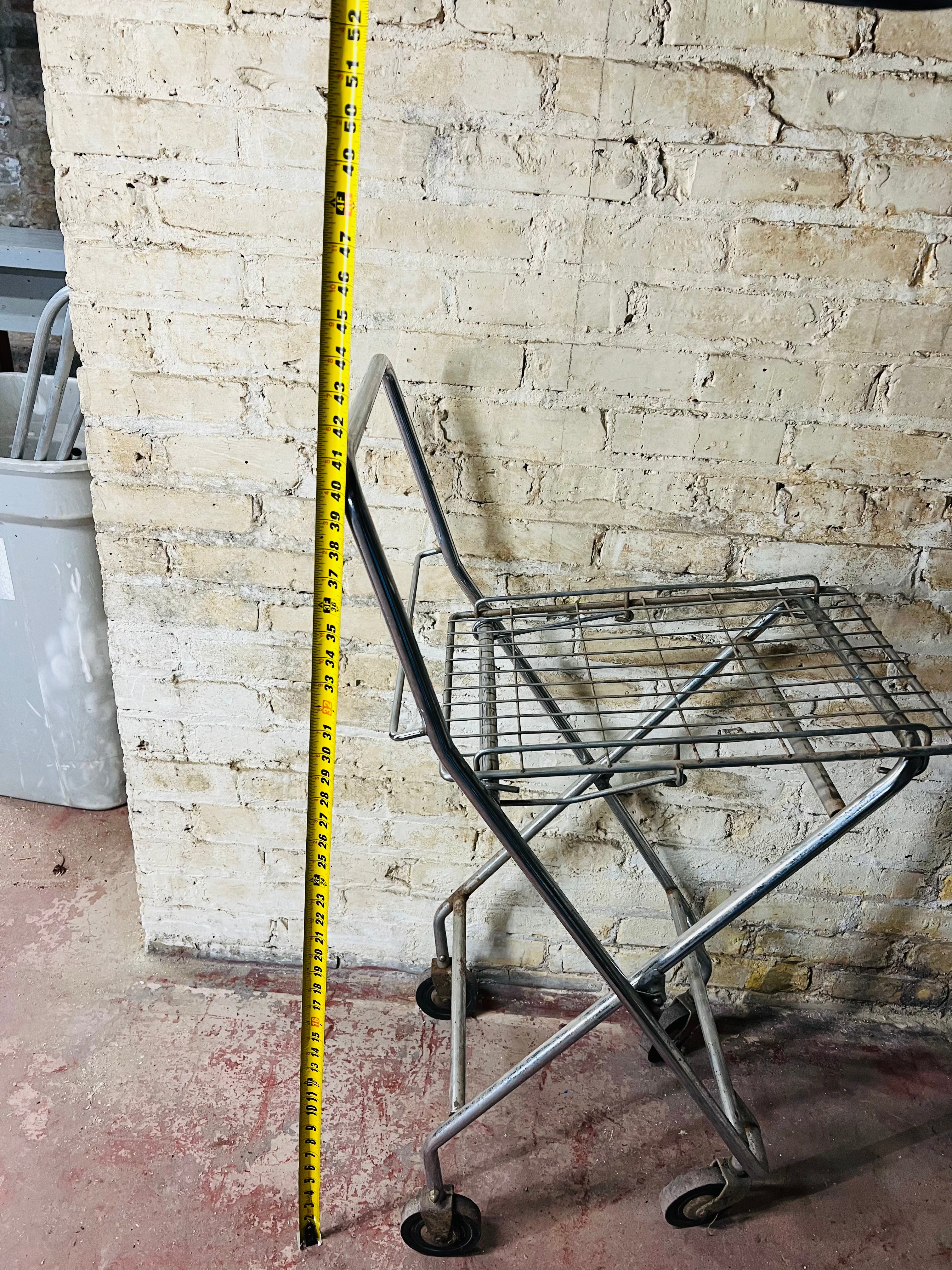 Vintage metal folding cart with wheels.