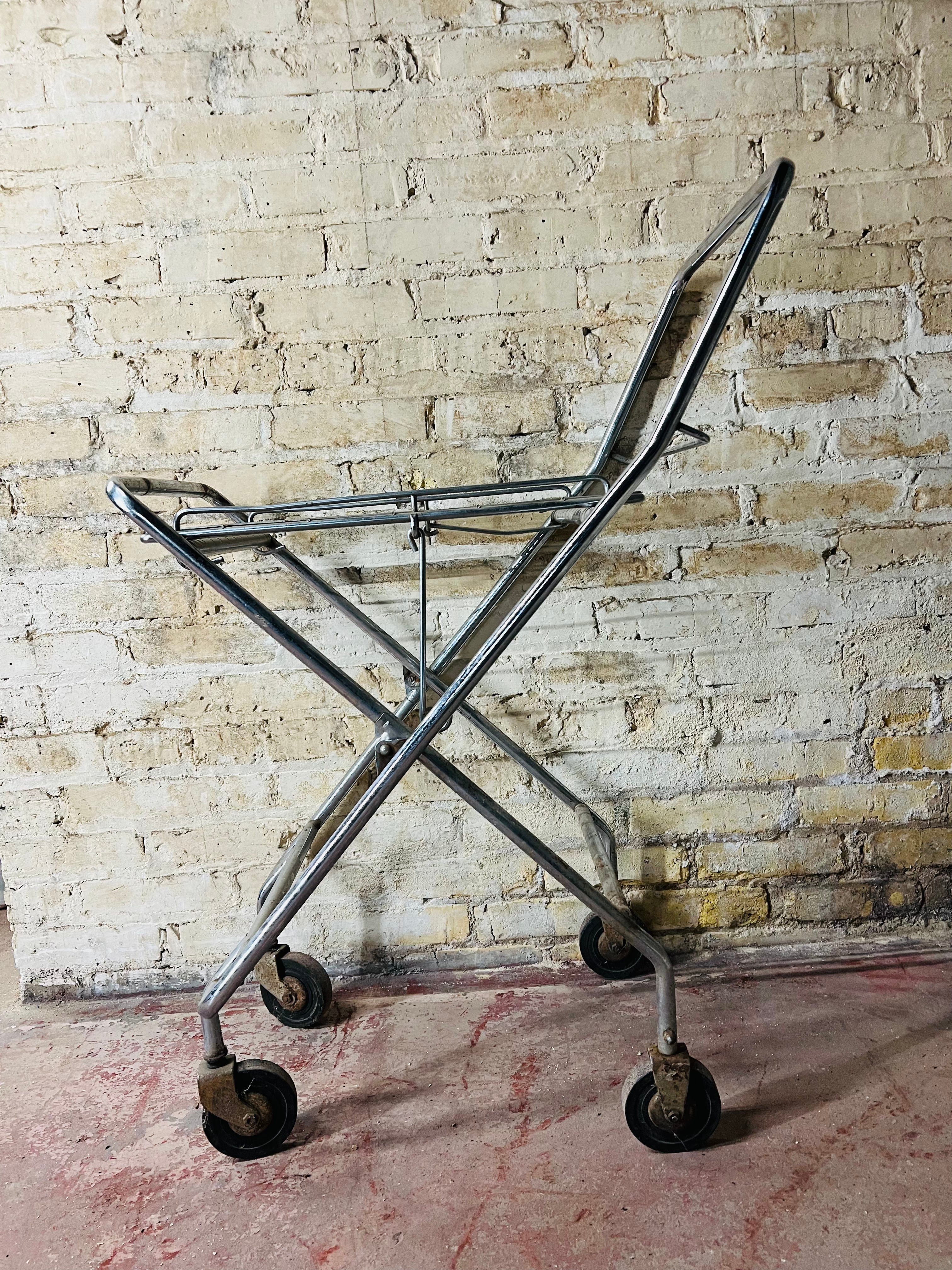 Vintage metal folding cart with wheels.