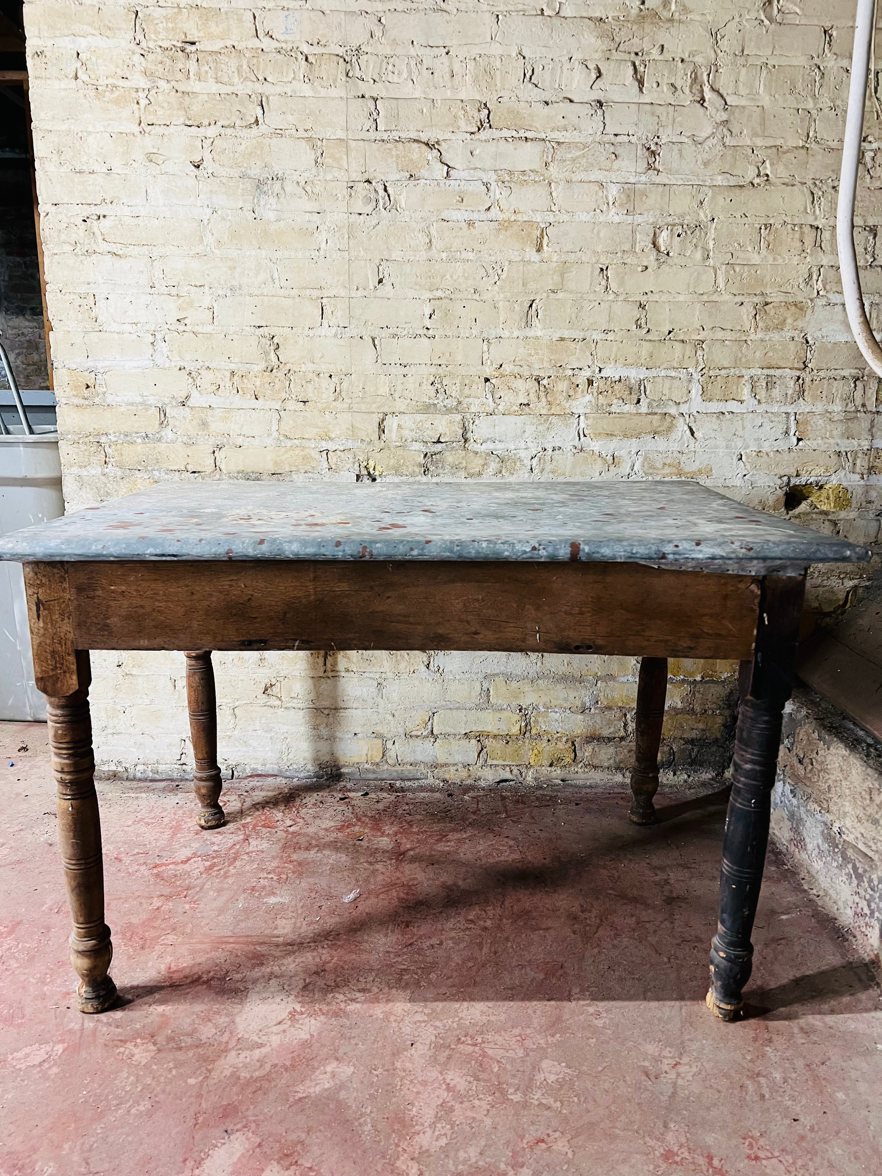 Vintage farm table with zinc top missing drawer.