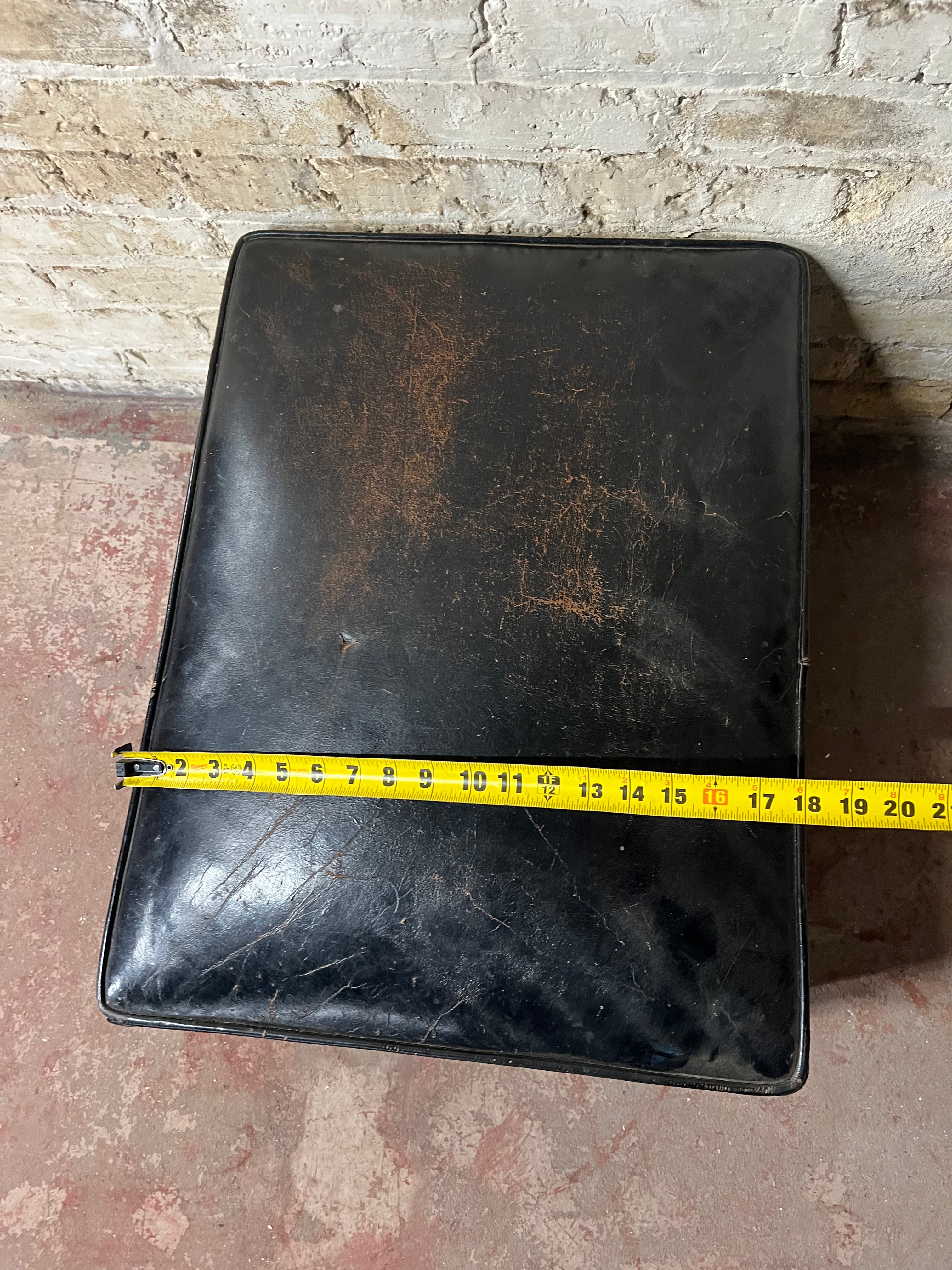Vintage leather ottoman on wheels.